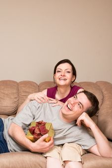 Man With Gift Box Lying On A Woman S Lap-Vertical Royalty Free Stock Image Man With Gift Box Lying On A Woman S Lap-Vertical Royalty Free Stock Image
