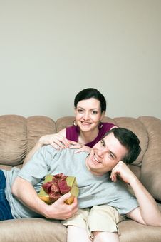 Man With Gift Box Lying On Woman S Lap-Vertic Stock Images Man With Gift Box Lying On Woman S Lap-Vertic Stock Images