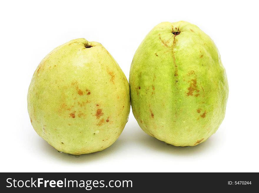 Two yellow green guavas isolated on white background.
