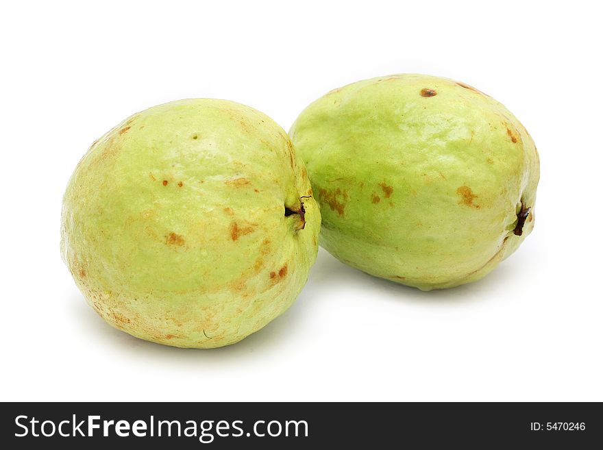 Two yellow green guavas isolated on white background.