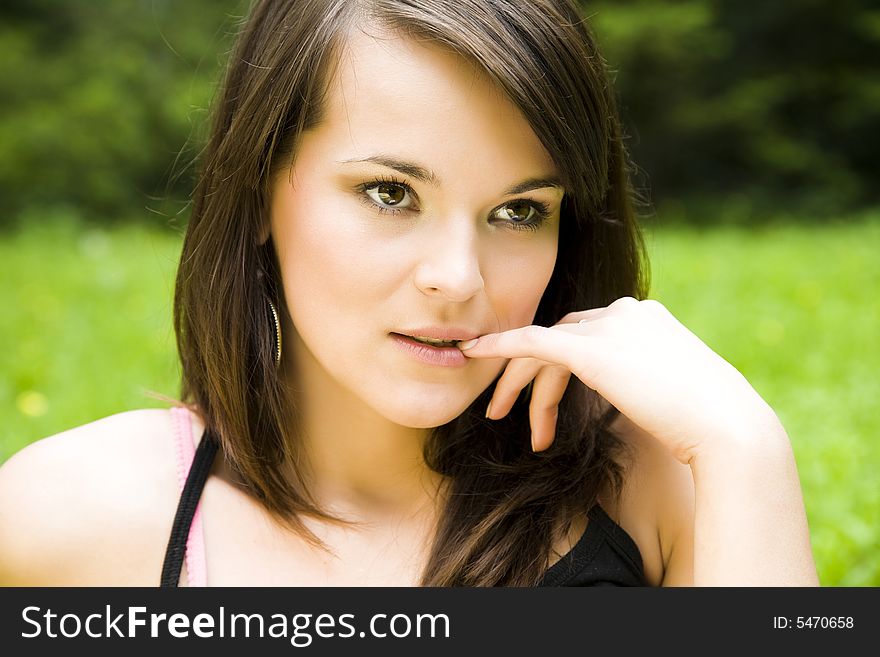 Beautiful young woman dreaming outdoors. Copy space.