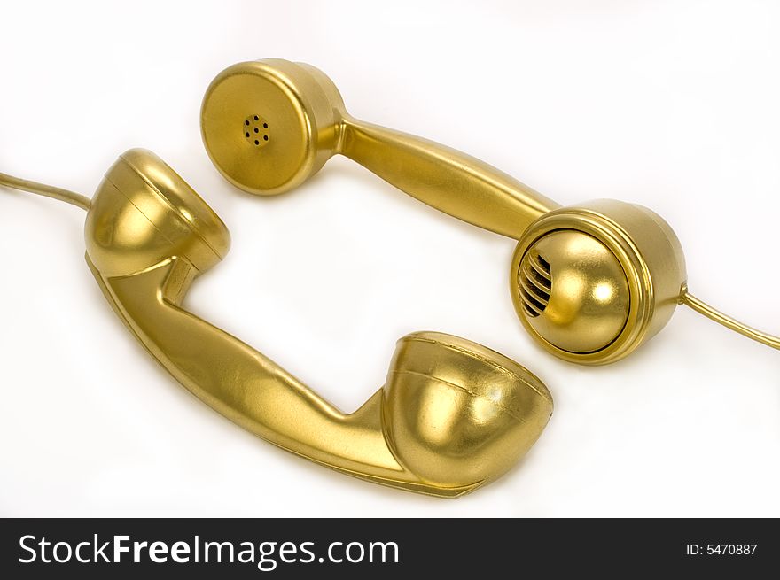 Two telephones of gold colour on a white background. Two telephones of gold colour on a white background.