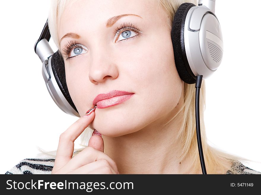 A pensive girl in headphones listening music