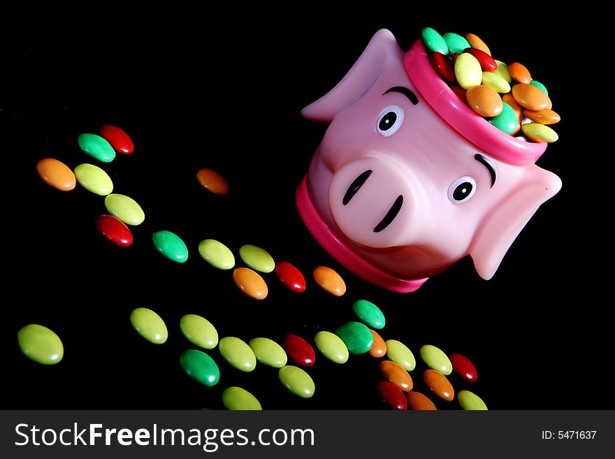 Many colored candies and a pig