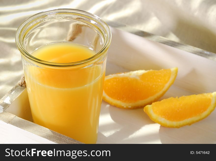 Orange juice in a glass on a tray