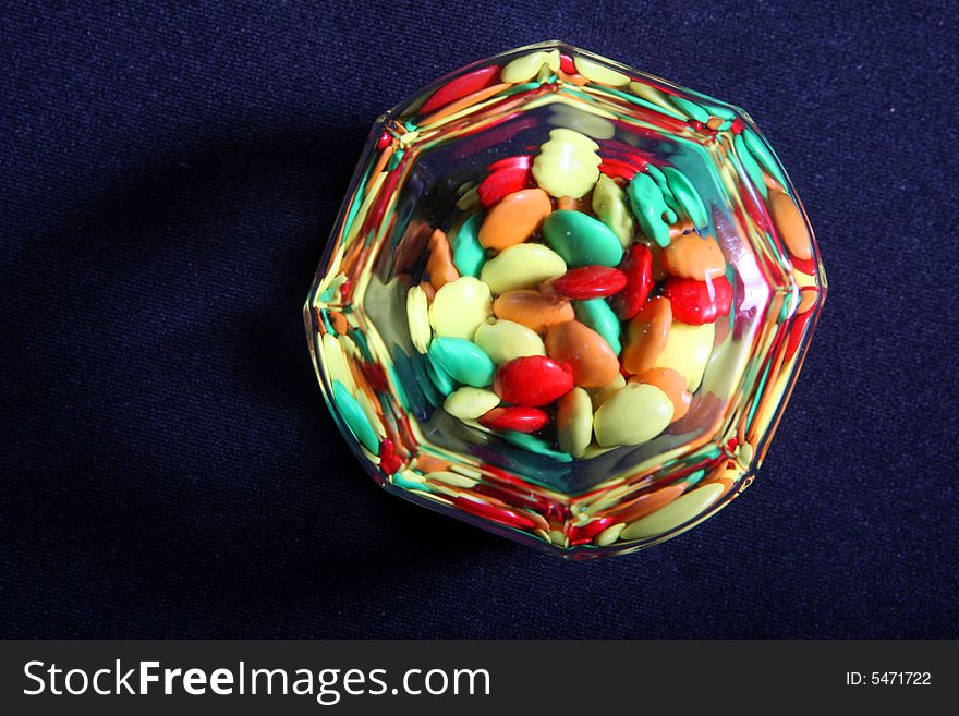 Many colored candies in a glass