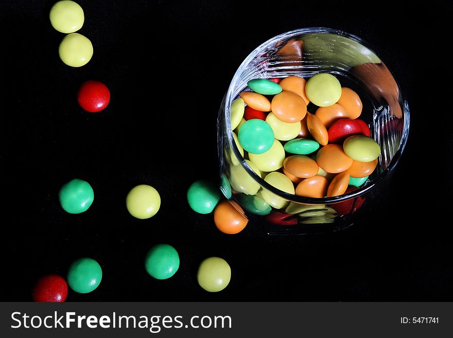 Many colored candies in a glass