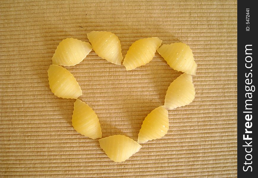 Top view of a love shape made by pasta shell