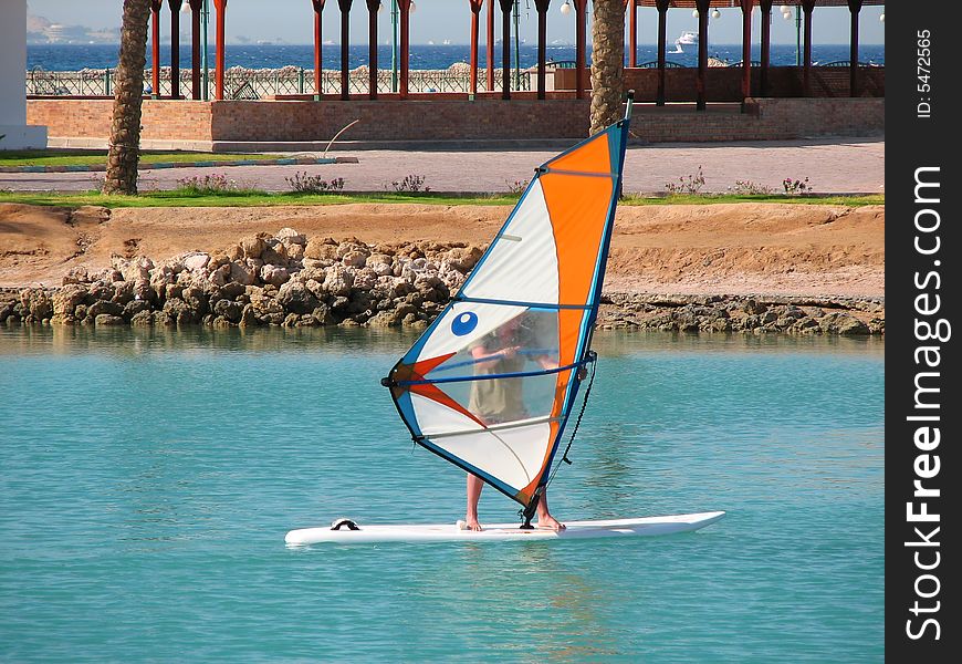 Man surfing on sea near coastline