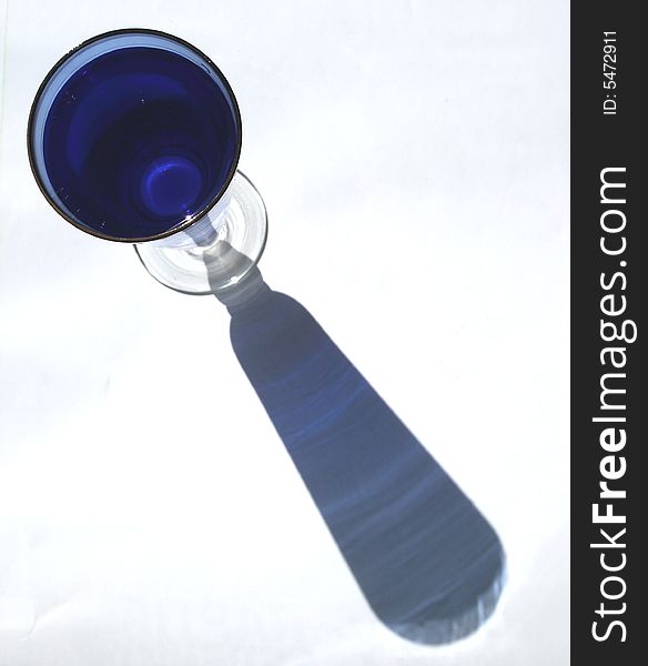 Blue glass with water on white background. Not isolated. Blue glass with water on white background. Not isolated