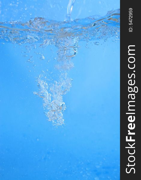 Photo of seething fresh water on the blue background. Photo of seething fresh water on the blue background