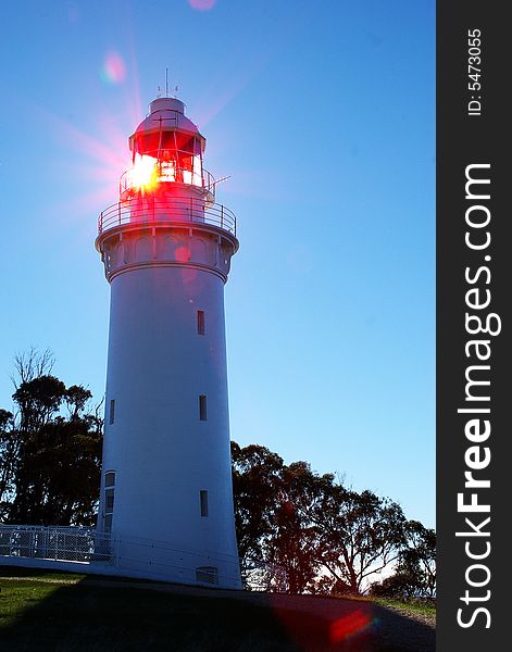 A lighthouse gives off light in the daytime. A lighthouse gives off light in the daytime.