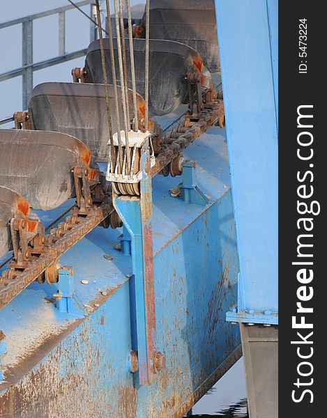 A detail view of a dredger in a gravel pit. A detail view of a dredger in a gravel pit.