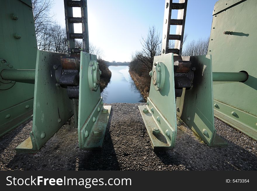 Gear boxes at a slut by a channel. Gear boxes at a slut by a channel.