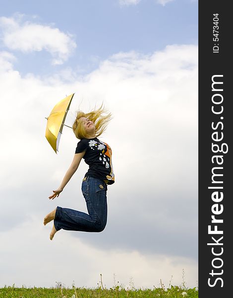 The young happy girl jumping with a umbrella