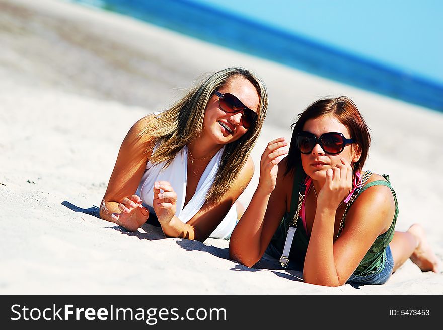 Young attractive girls enjoying together the summer beach. Young attractive girls enjoying together the summer beach