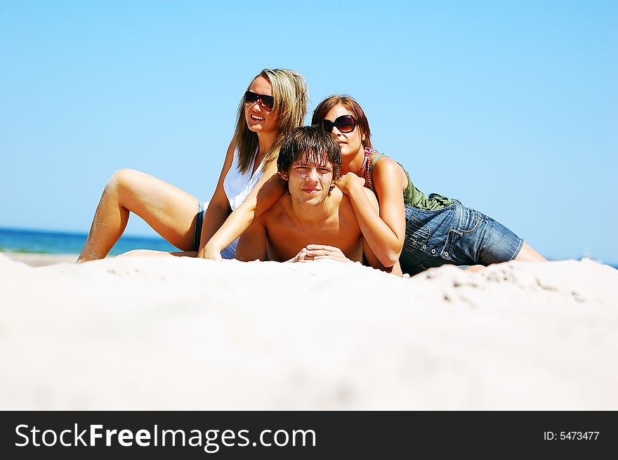 Young attractive friends enjoying together the summer beach. Young attractive friends enjoying together the summer beach