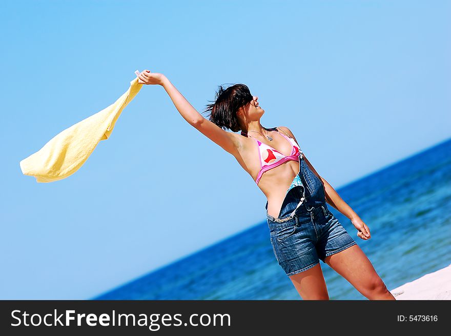 Young attractive woman enjoying summertime on the beach. Young attractive woman enjoying summertime on the beach