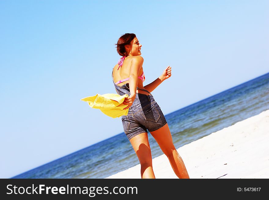 Young attractive woman enjoying summertime on the beach. Young attractive woman enjoying summertime on the beach