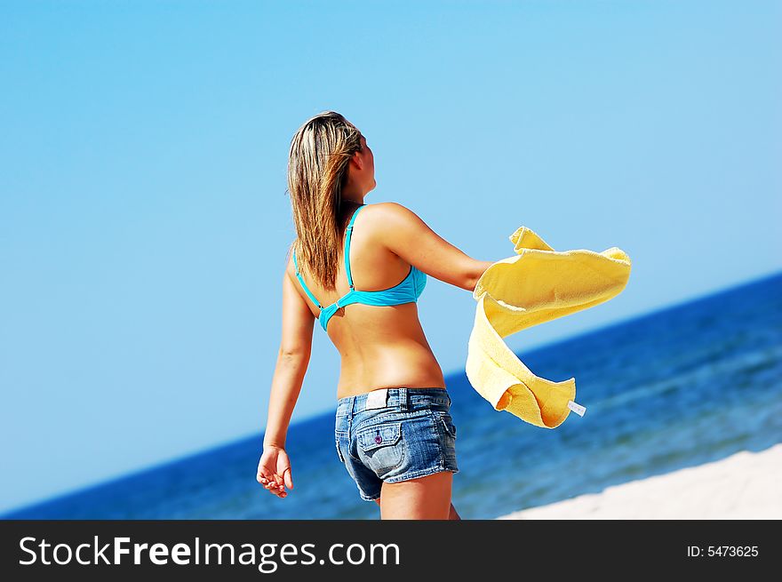 Young attractive woman enjoying summertime on the beach. Young attractive woman enjoying summertime on the beach