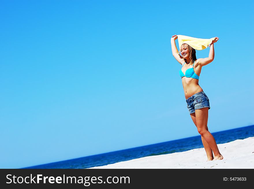 Young attractive woman enjoying summertime on the beach. Young attractive woman enjoying summertime on the beach