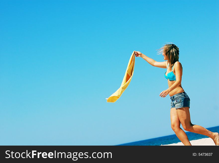 Young attractive woman enjoying summertime on the beach. Young attractive woman enjoying summertime on the beach