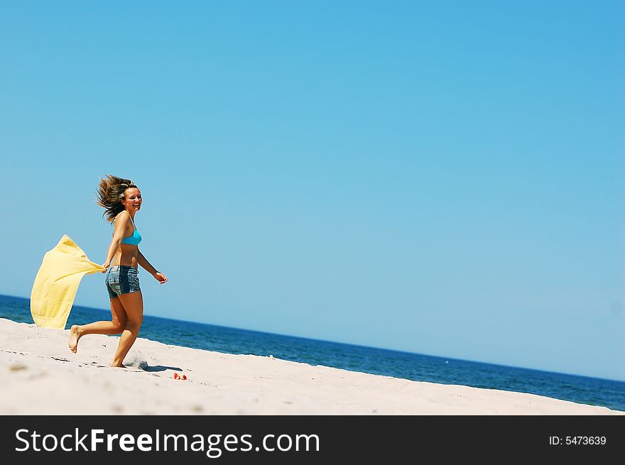 Young attractive woman enjoying summertime on the beach. Young attractive woman enjoying summertime on the beach