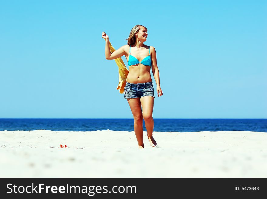 Young attractive woman enjoying summertime on the beach. Young attractive woman enjoying summertime on the beach