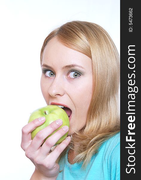 The girl on a white background bites an apple. The girl on a white background bites an apple