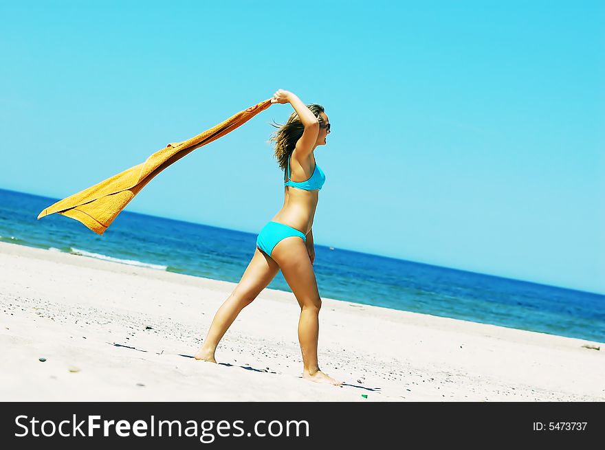 Young attractive woman enjoying summertime on the beach. Young attractive woman enjoying summertime on the beach