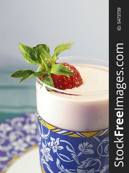 Strawberry and glass of yogurt