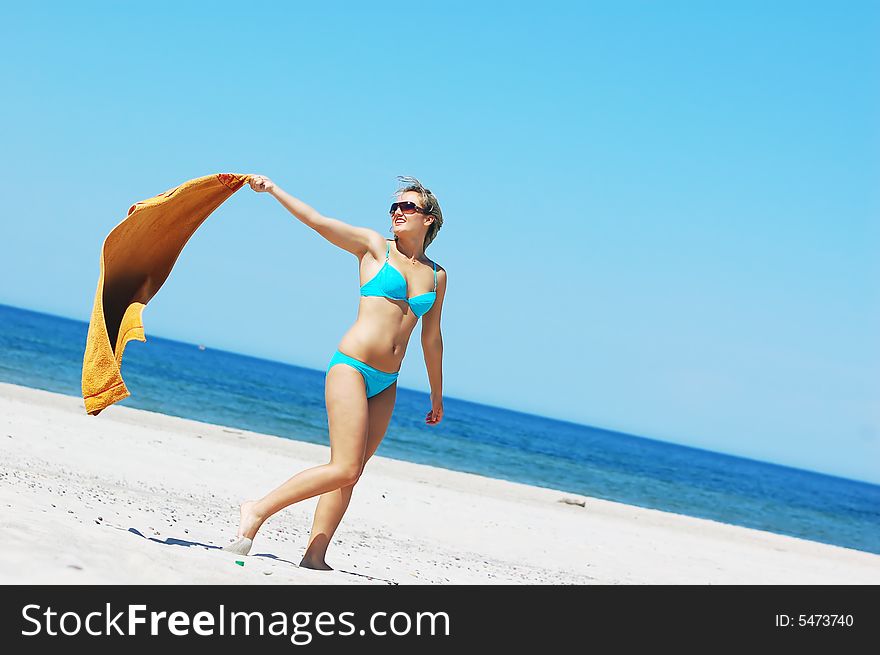 Young attractive woman enjoying summertime on the beach. Young attractive woman enjoying summertime on the beach