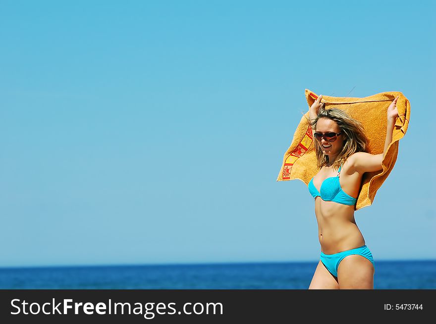 Young attractive woman enjoying summertime on the beach. Young attractive woman enjoying summertime on the beach