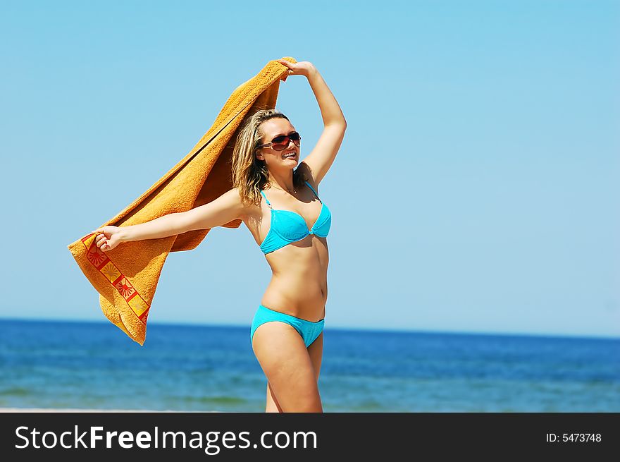 Young attractive woman enjoying summertime on the beach. Young attractive woman enjoying summertime on the beach