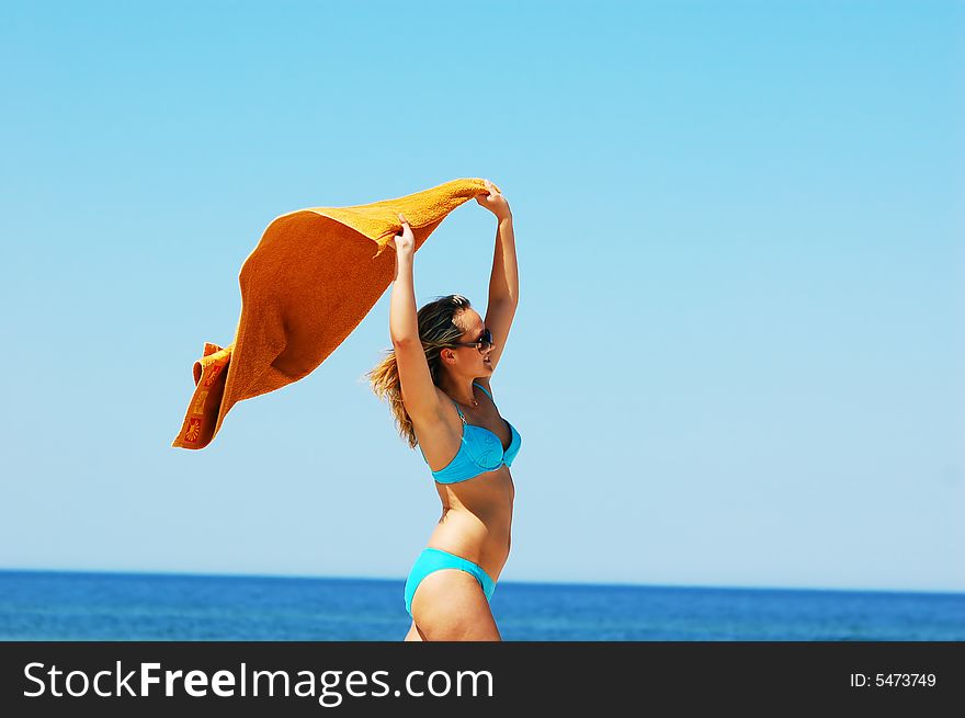 Young attractive woman enjoying summertime on the beach. Young attractive woman enjoying summertime on the beach