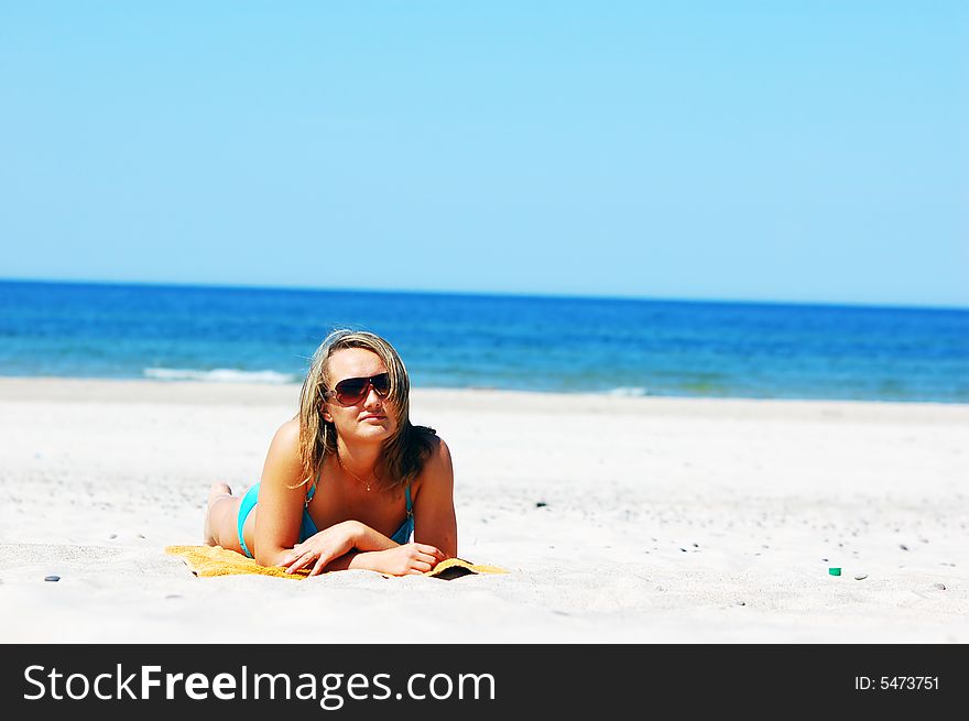 Beautiful woman relaxing on the beach. Lots of useful copyspace. Beautiful woman relaxing on the beach. Lots of useful copyspace