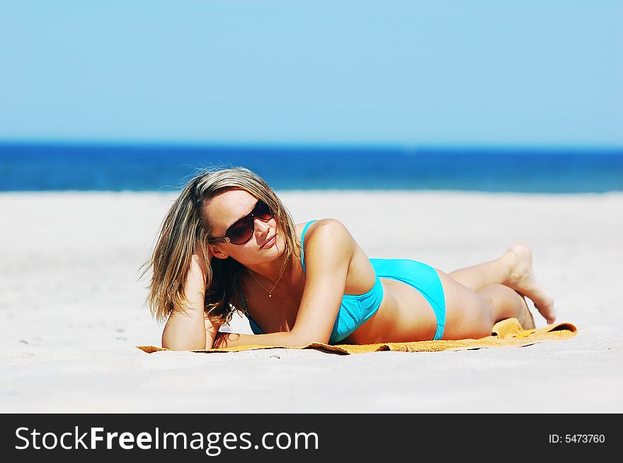 Beautiful woman relaxing on the beach. Lots of useful copyspace. Beautiful woman relaxing on the beach. Lots of useful copyspace