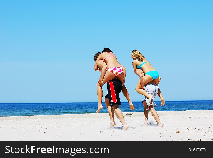 Young attractive friends having fun the summer beach. Young attractive friends having fun the summer beach
