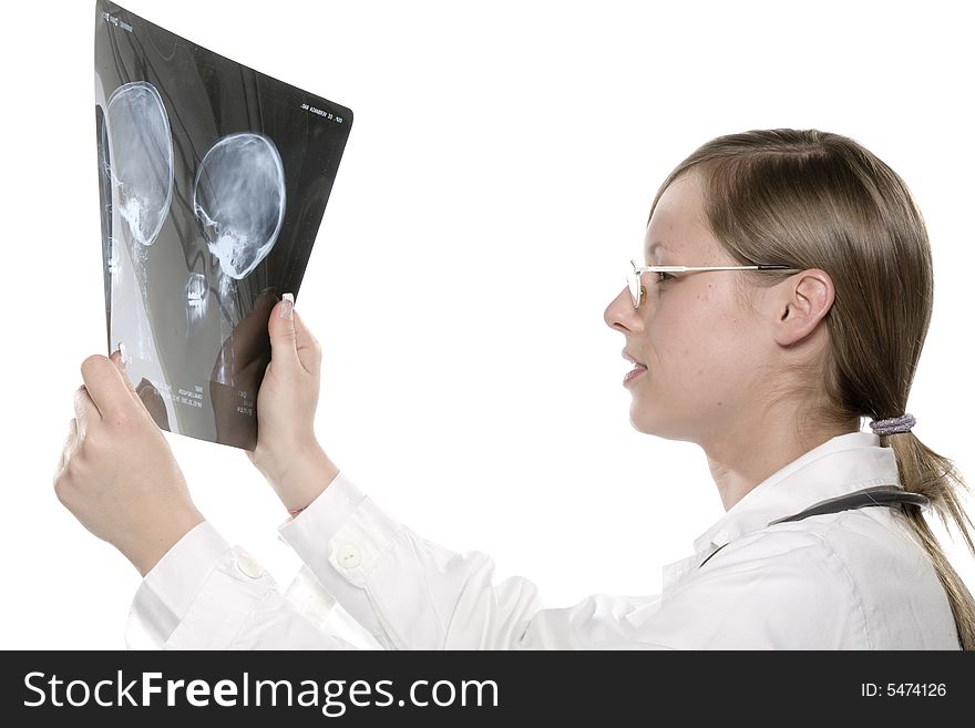 Young and beautiful doctor looking at x-ray. Young and beautiful doctor looking at x-ray