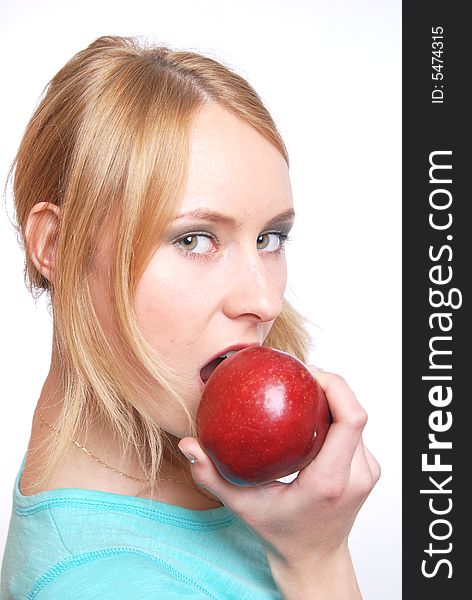The girl on a white background bites an apple. The girl on a white background bites an apple