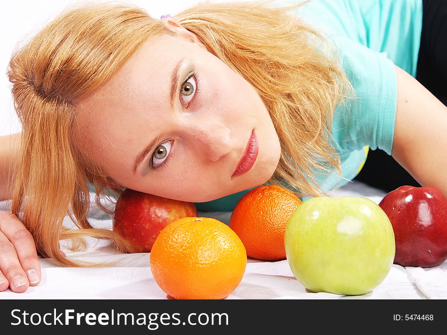 The girl with  fruit on a white background. The girl with  fruit on a white background