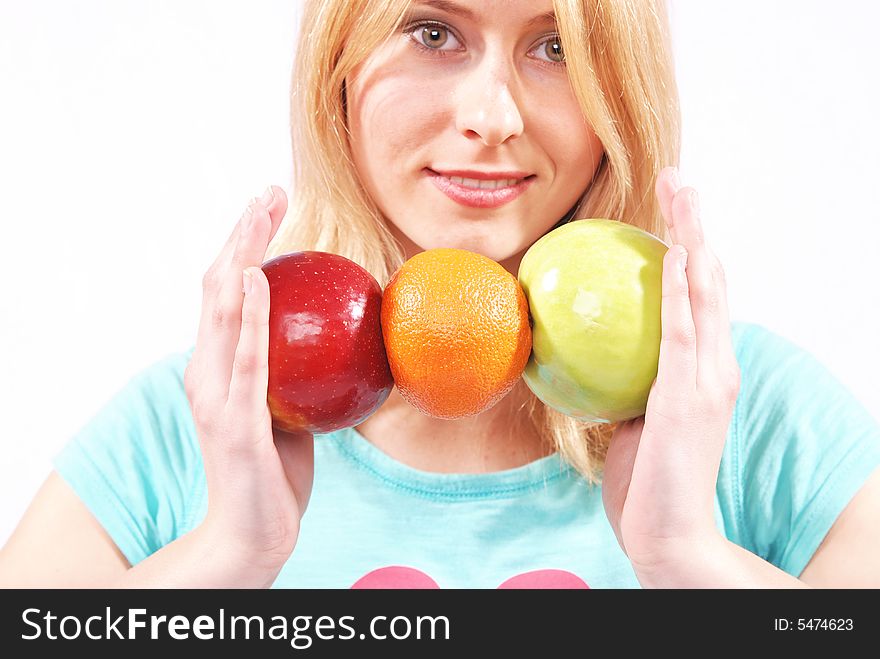 The girl on a white background gives fruit. The girl on a white background gives fruit