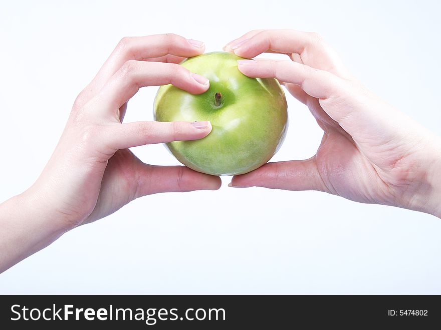 Two hands hold an apple on Ð±Ð¾Ð»Ð¾Ð¼ a background. Two hands hold an apple on Ð±Ð¾Ð»Ð¾Ð¼ a background