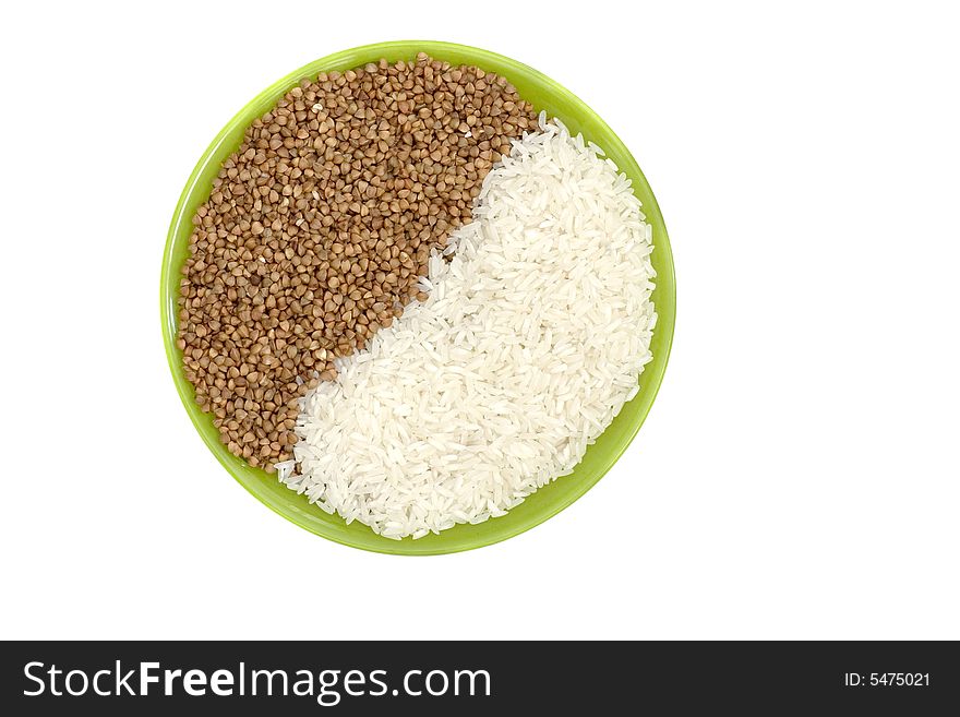 Rice and buckwheat in green plate on the white background.