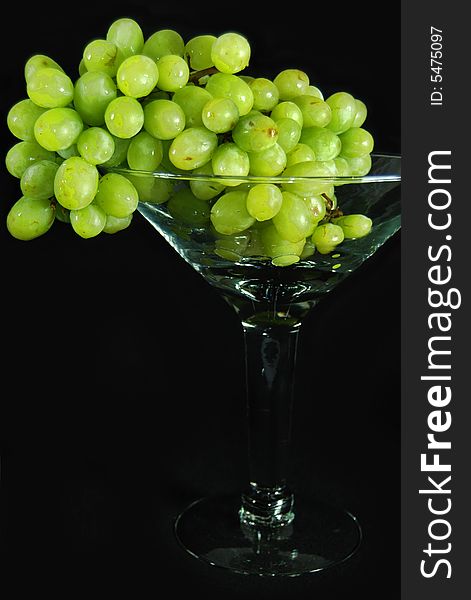 Ripe and juicy green grapes in a glass goblet. Ripe and juicy green grapes in a glass goblet.