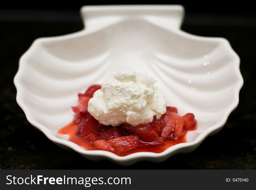 Strawberry and whipped cream dessert in a clamshell bowl. Strawberry and whipped cream dessert in a clamshell bowl