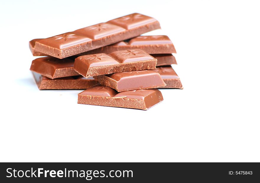 Delicious pieces of milk chocolate isolated