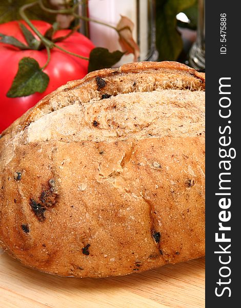 Whole olive bread loaf in kitchen or restaurant.