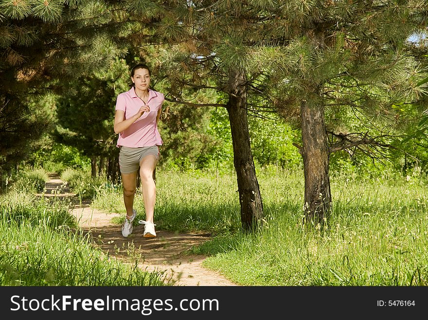 A female runner in a field, note there is some motion blur