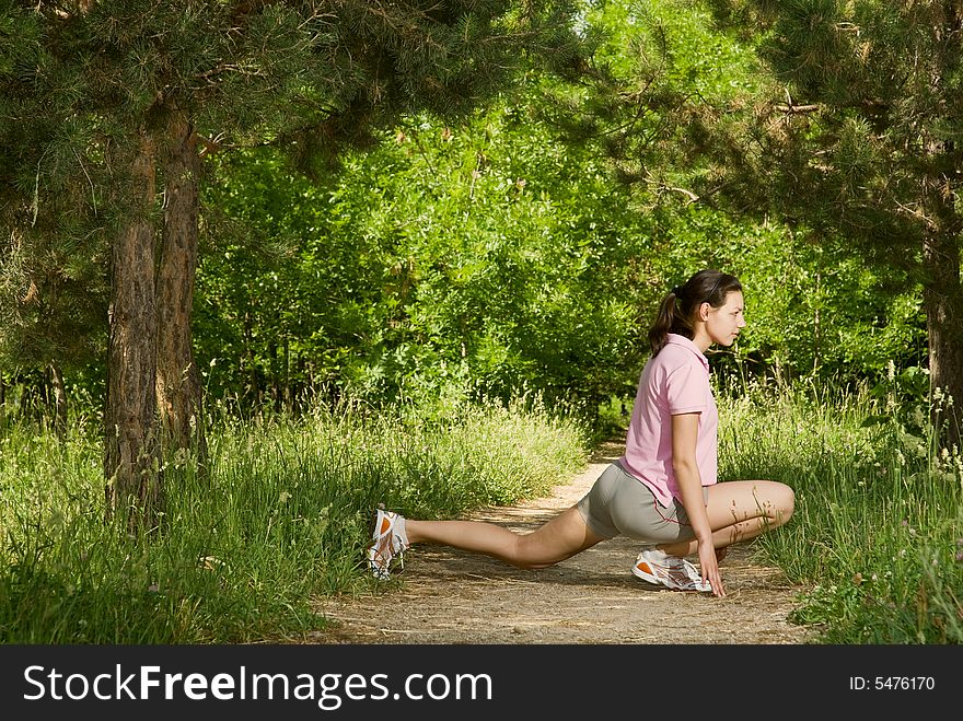 Young attractive woman making exercise alone in the park in a sunny day. Young attractive woman making exercise alone in the park in a sunny day
